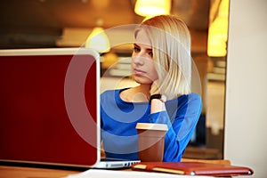Woman sitting at the table with laptop