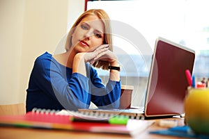 Woman sitting at the table with laptop