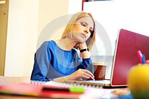 Woman sitting at the table with laptop