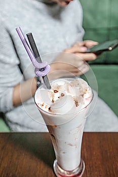 Woman Sitting at Table Using Cell Phone