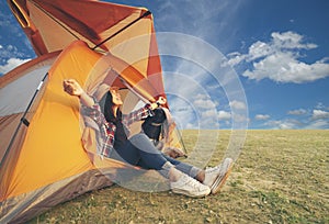 Woman sitting in tent and open arm