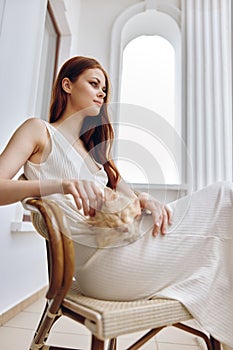 woman sitting on the terrace with a cat Happy female relaxing