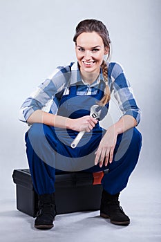 Woman sitting on toolbox