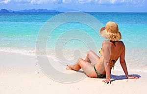 Woman sitting on a tropical beach