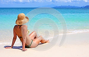 Woman sitting on a tropical beach