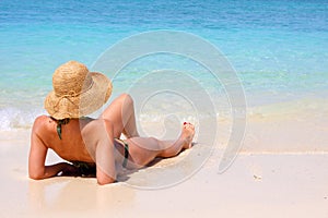 Woman sitting on tropical beach