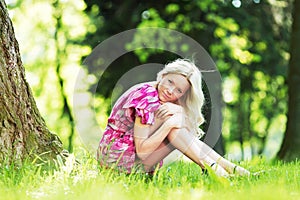 Woman sitting under tree