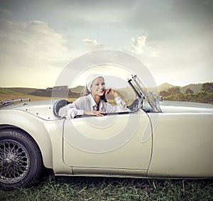 Woman sitting in a vintage car