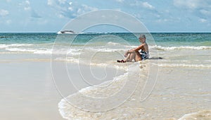 Woman sitting in water at beach