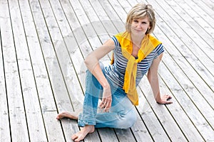 Woman sitting on the weathered wooden floor