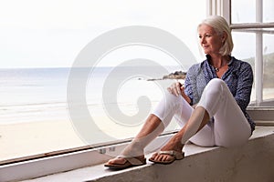 Woman Sitting At Window And Looking At Beautiful Beach View