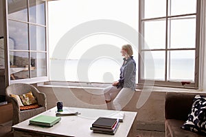 Woman Sitting At Window And Looking At Beautiful Beach View