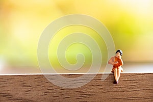 Woman sitting on wood green nature background