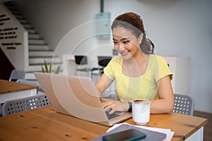 Woman sitting working with laptop at coffee shop, freelance woman working outside Concept