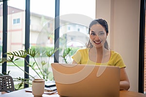 Woman sitting working with laptop at coffee shop, freelance woman working outside Concept