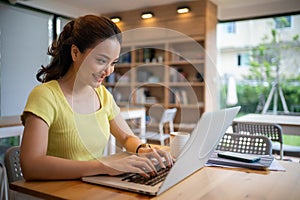 Woman sitting working with laptop at coffee shop, freelance woman working outside Concept