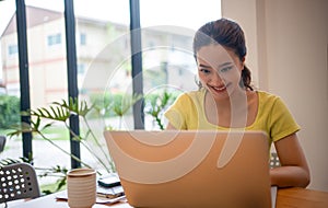 Woman sitting working with laptop at coffee shop, freelance woman working outside Concept