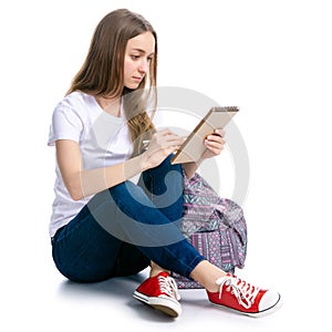 Woman sitting writing in notebook with pen backpack