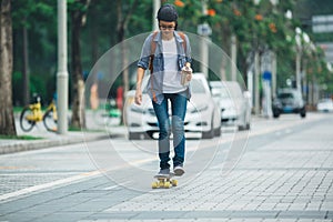 Woman skateboarding with coffee cup in hand