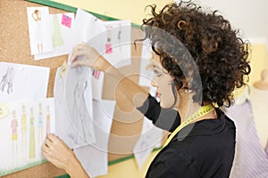 Woman with sketches in fashion design studio