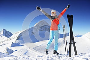 Woman in Ski resort jumping and smiling