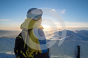 Woman skier looking at sunset above slovakia mountains