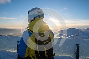 Woman skier looking at sunset above slovakia mountains