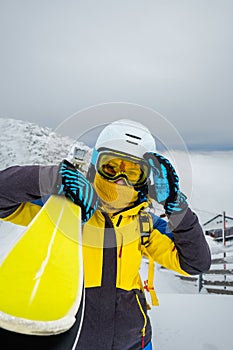 woman skier posing on the top of snowed mountain