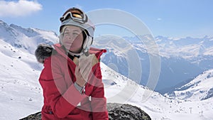 Woman Skier Sits On A Stone In The Mountains Ski Resort And Eats A Sandwich