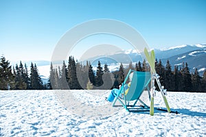 woman skier sitting in the chair with beautiful mountains panoramic view