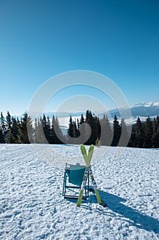 woman skier sitting in the chair with beautiful mountains panoramic view