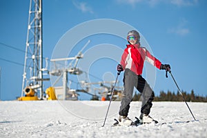 Woman skier with ski at winer resort in sunny day