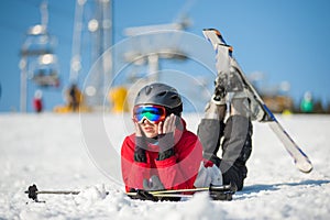 Woman skier with ski at winer resort in sunny day