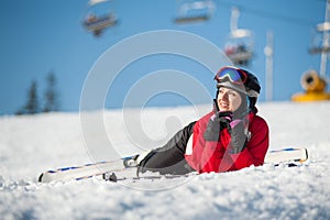 Woman skier with ski at winer resort in sunny day