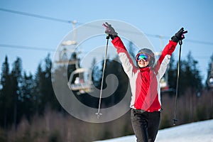 Woman skier with ski at winer resort in sunny day