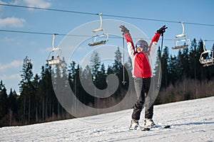 Woman skier with ski at winer resort in sunny day