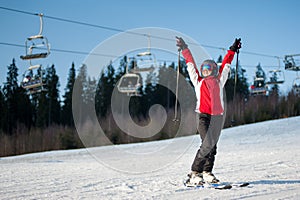 Woman skier with ski at winer resort in sunny day