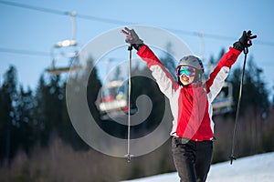 Woman skier with ski at winer resort in sunny day