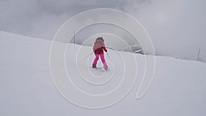 Woman Skier Skiing Down The Mountain Slope In A Heavy Fog