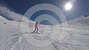 Woman Skier Skiing Down On The Ski Slope In Winter Mountains On A Sunny Day