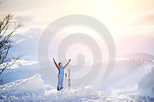 Woman skier on the top of the mountain