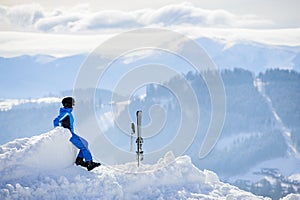 Woman skier on top of the mountain. Winter sports concept