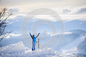 Woman skier on top of the mountain. Winter sports concept