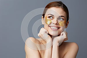 woman skin care face patches bare shoulders  background