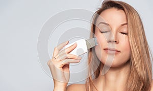 Woman with skin care treatment device.