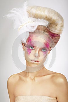 Woman with Skin Colored Pink, False Lashes and White Feather