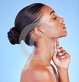 Woman, skin and profile of natural beauty, skincare or shine from cosmetics on blue background in studio with calm model