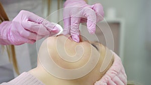 A woman during a skin rejuvenation procedure in a beauty salon. Cosmetology, skin care