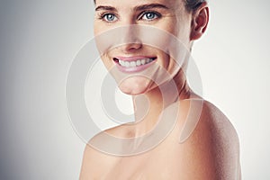 Woman, skincare and happy in studio for beauty with soft, smooth and clear skin with wellness. Girl, isolated and white