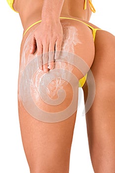 Woman Skincare moisturizer cream on legs and